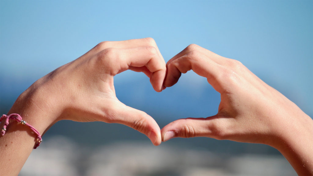 Hands forming a heart in front of sky Complete Healthcare Primary Care and Gynecology