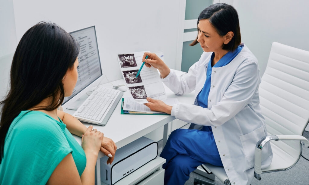 Female doctor going over some scans with female patient