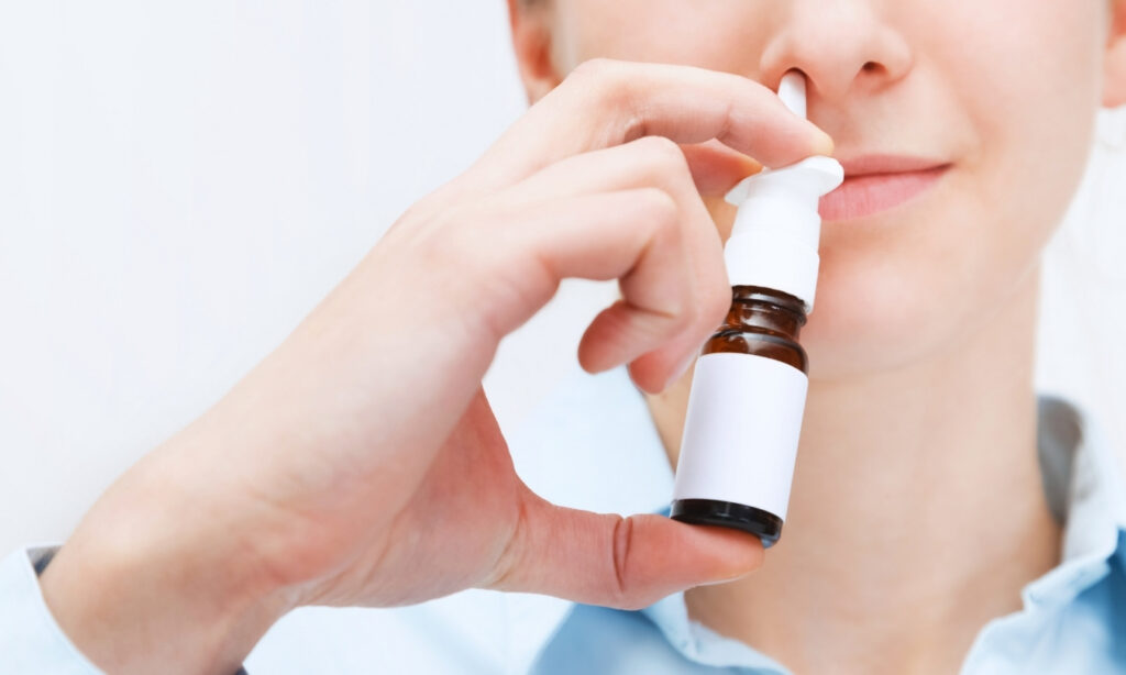 Woman using a nasal spray