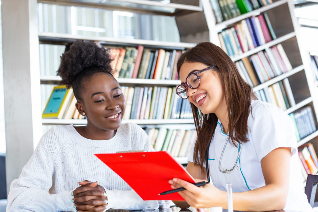 Smiling patient receiving advice from a helpful nurse practitioner from Complete Healthcare Primary Care and Gynecology